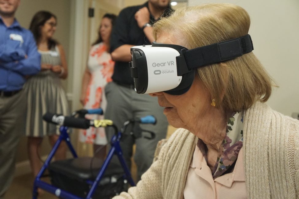One of Maplewood's residents uses a Rendever VR headset to experience virtual reality in a group session. (Maplewood Senior Living)
